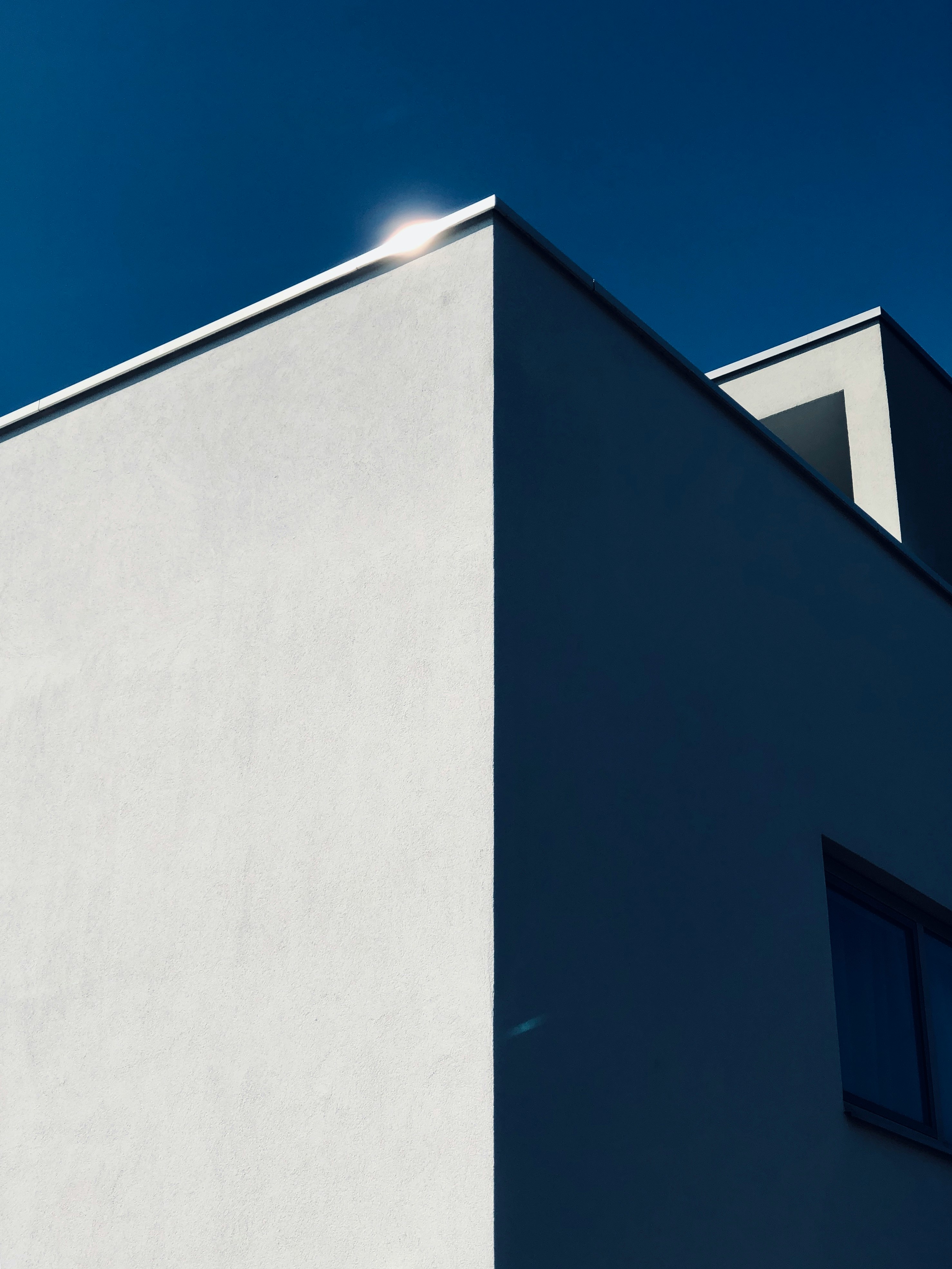 low-angle photography of concrete building under blue sky